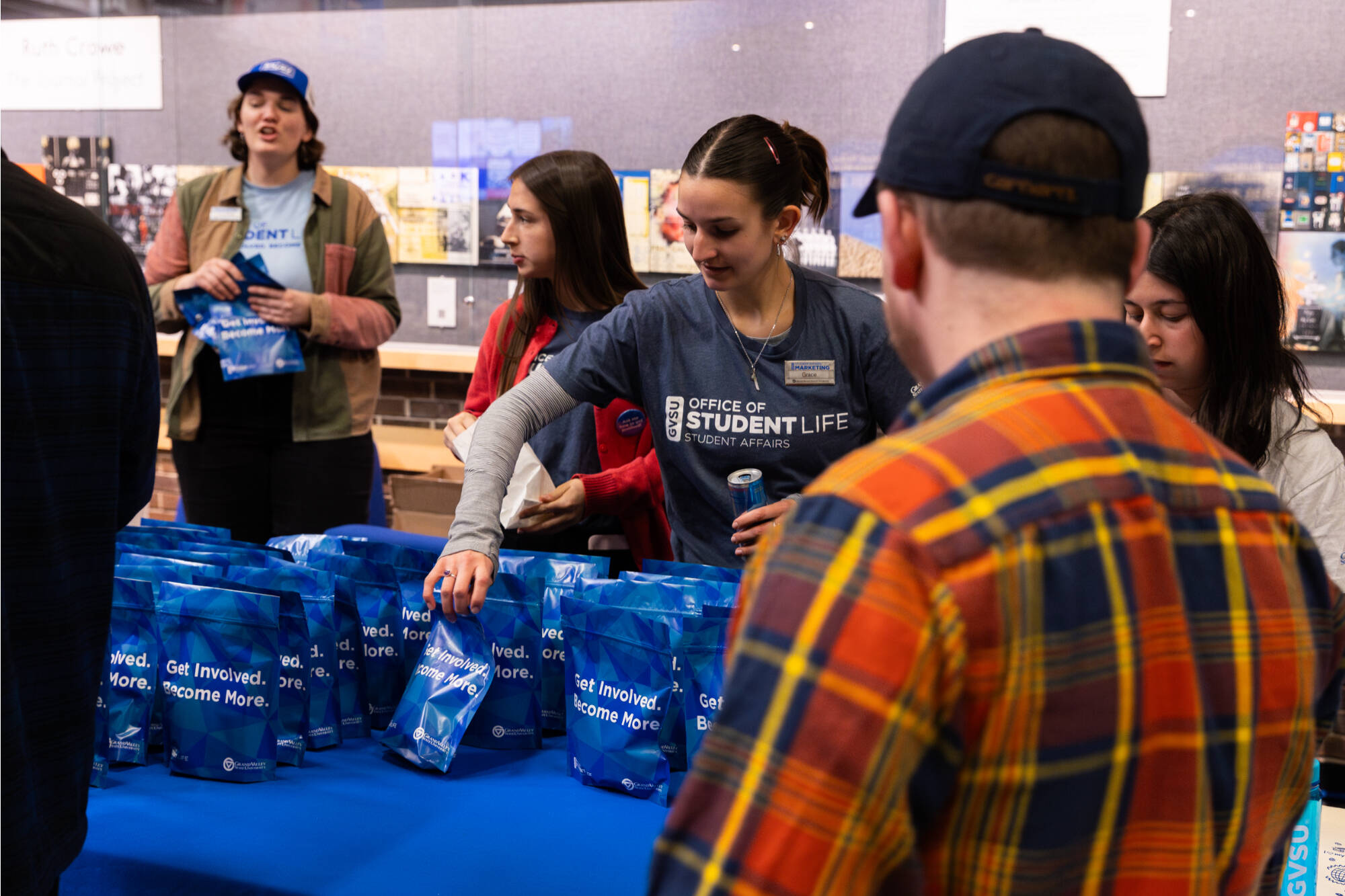 Student hands another student a goodie bag